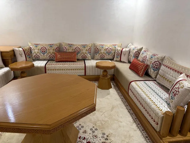 صالون مغربي كريمي بالورود مع طاولة خشبية مثمنة